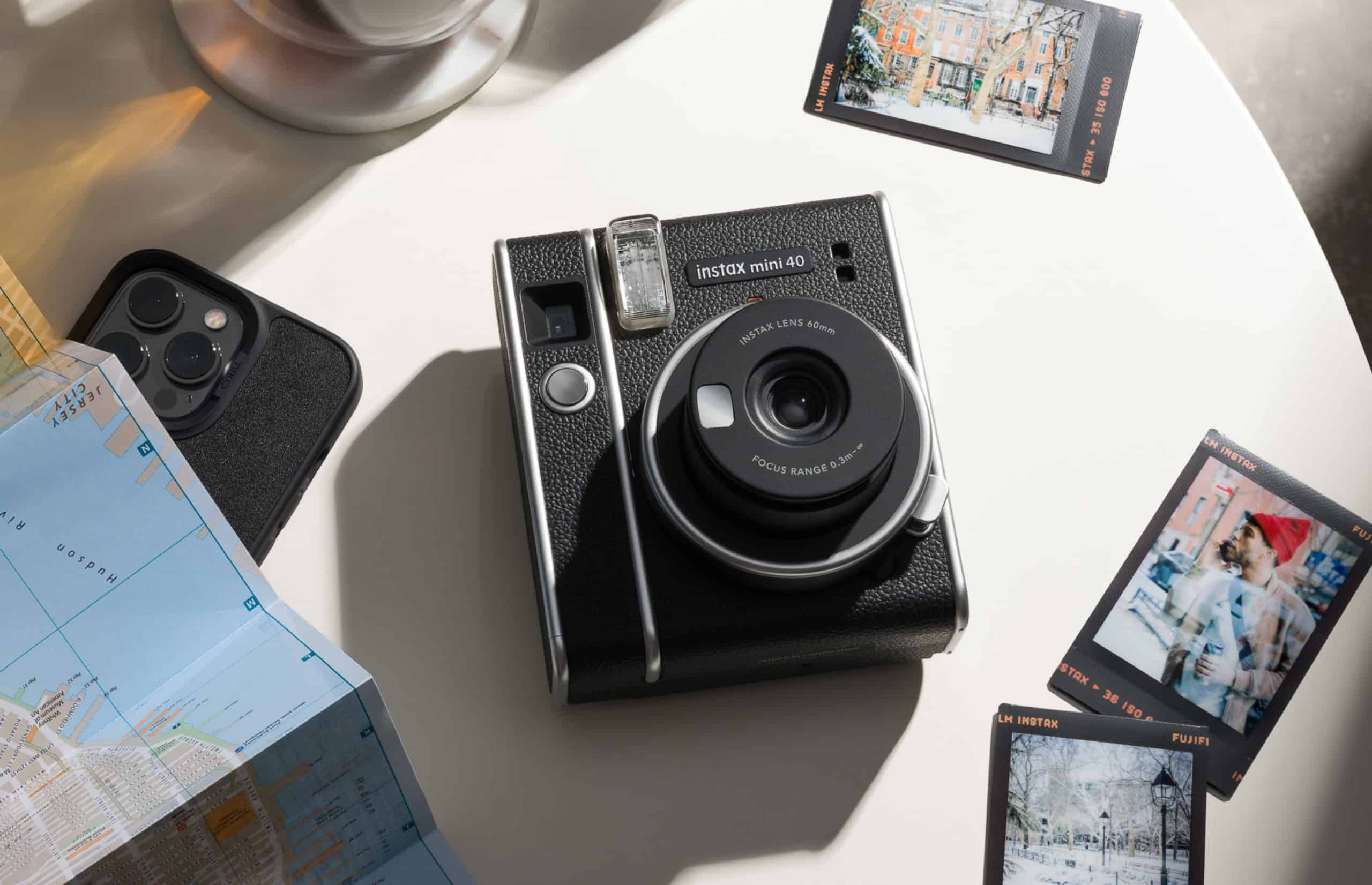 instax mini 40 with prints on a table